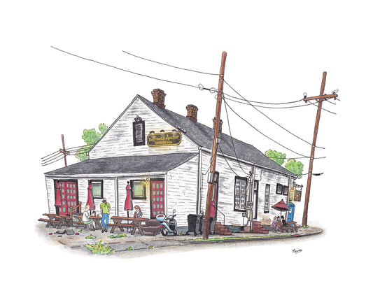 A product photo of the Crown and Anchor Pub art print. A white building with red & black trim and a high pitched roof faces you with a 2 point perspective. 3 chimneys sit on the top of the roof. Power lines, sidewalk, picnic tables, and local patrons surround the building. A black sign with gold, old English style lettering illuminated by three overhead lights reads "The Crown and Anchor English Pub". The image floats on a white background.