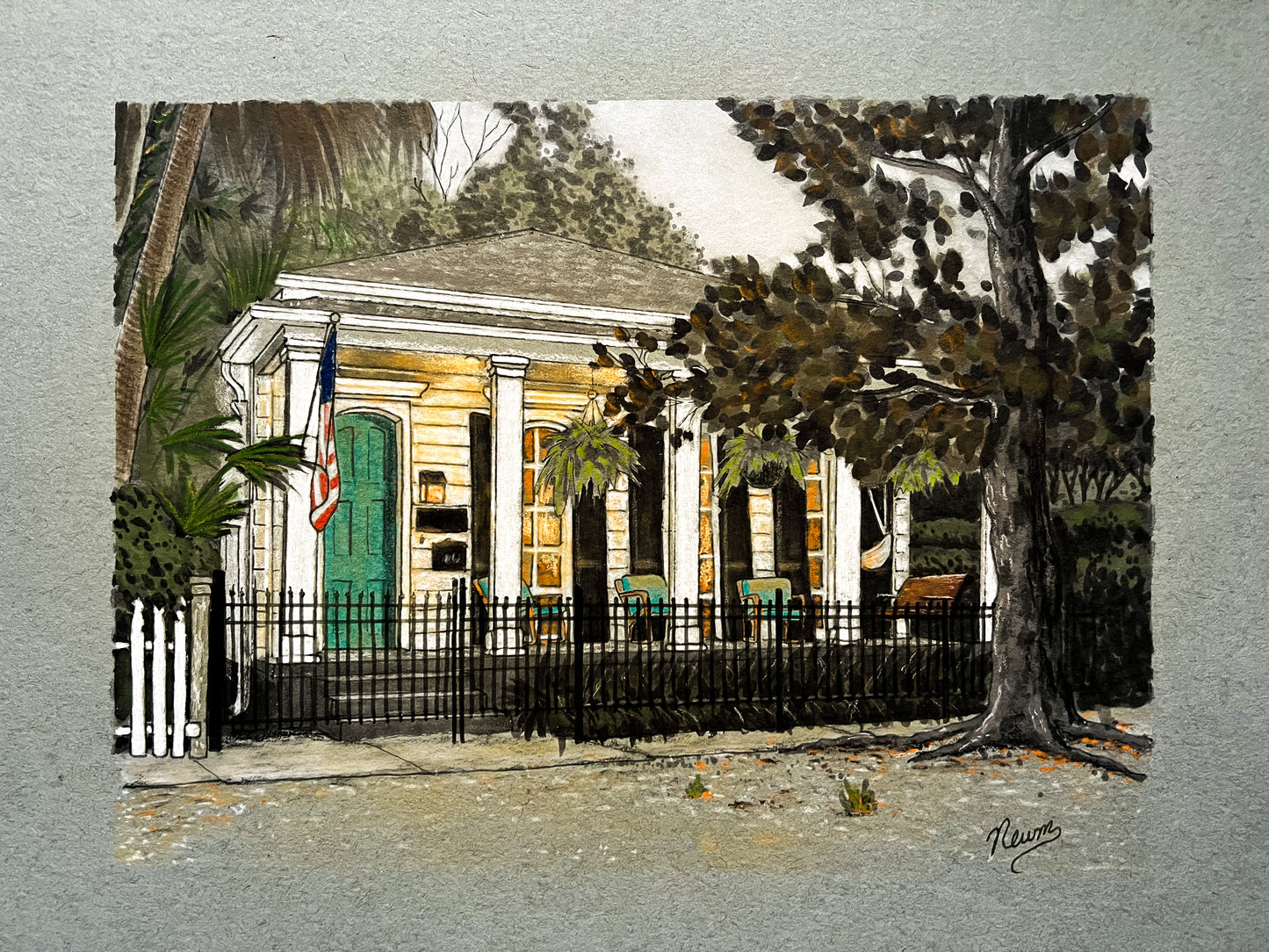 An example of a pastel custom home portrait commission art. A painting of a house with a green door and American flag, surrounded by trees and a fence.