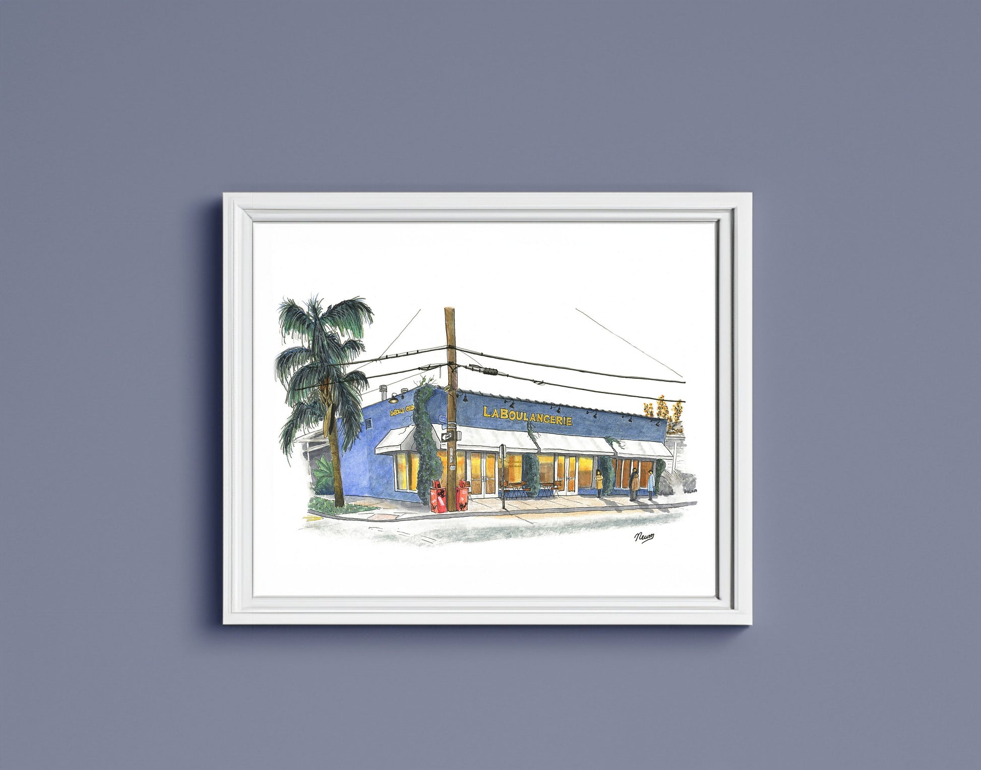 The finished piece in a simple white frame hangs on a cobalt colored wall. The image which floats on a white background matches the white frame.