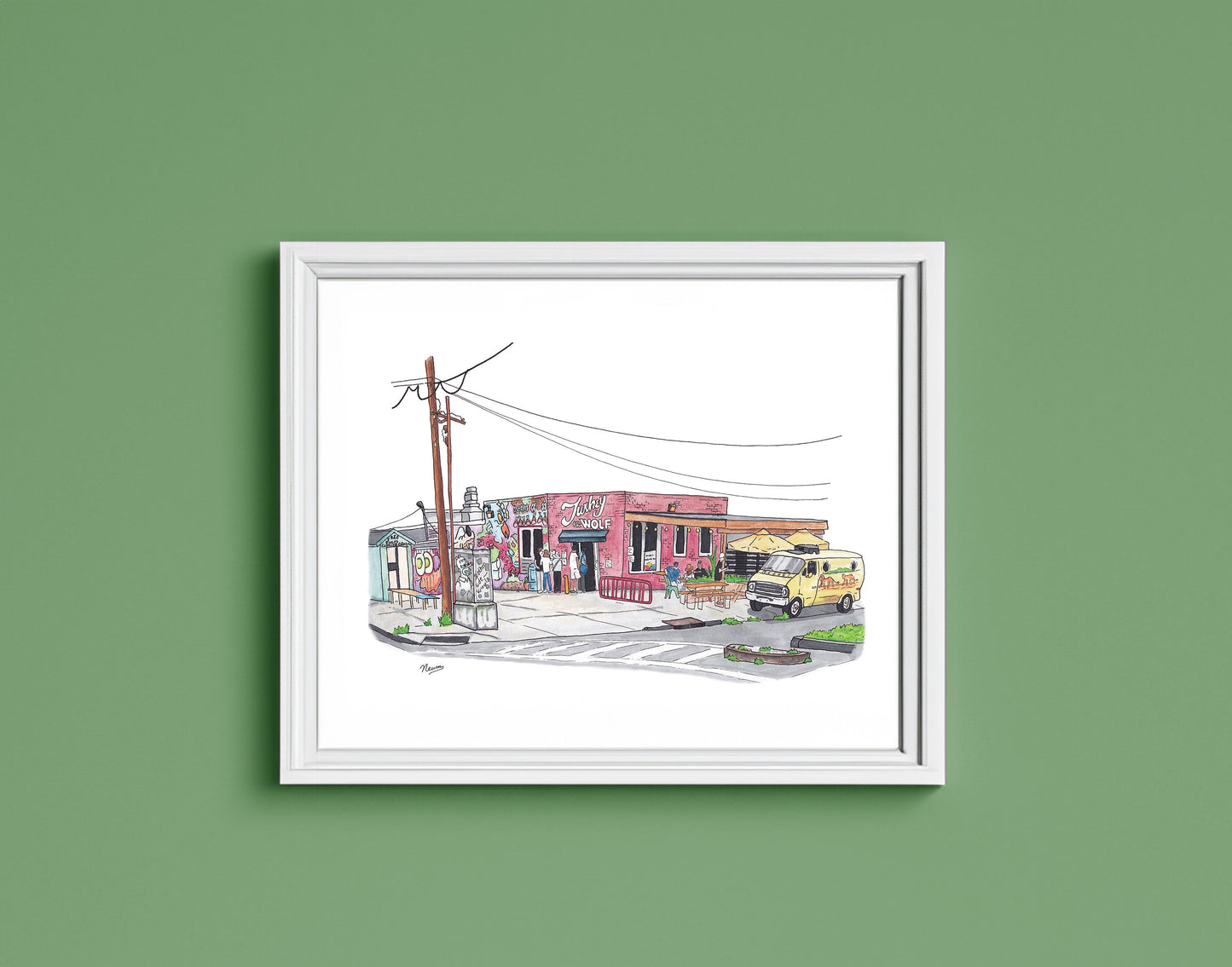 The finished piece is hung on a soft green wall in a simple white frame.